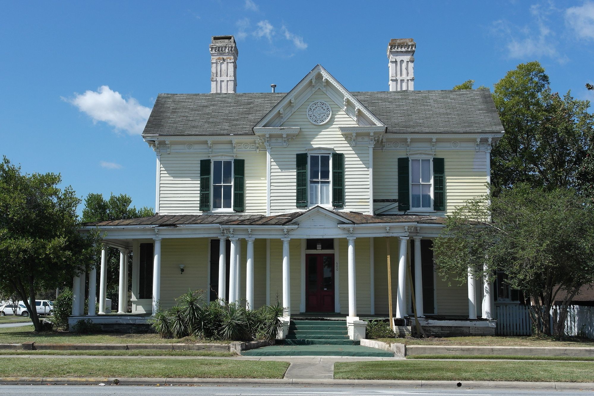 Brick house with white columns and a porch in Kinston