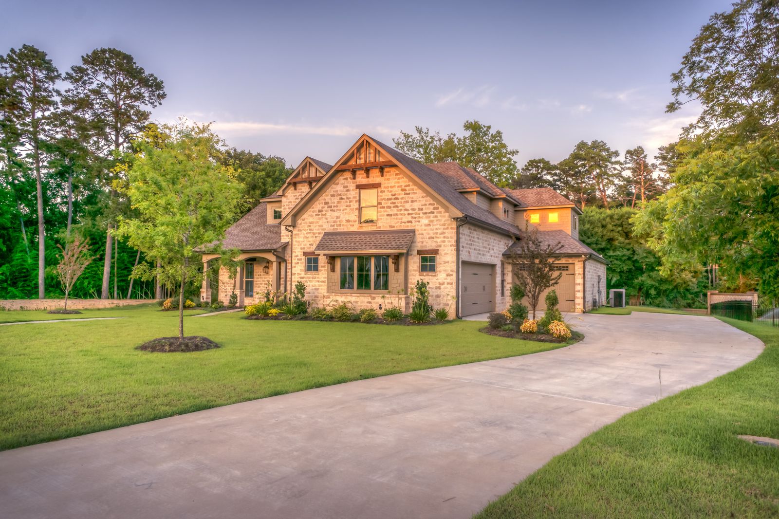Yellow house with a porch under the trees