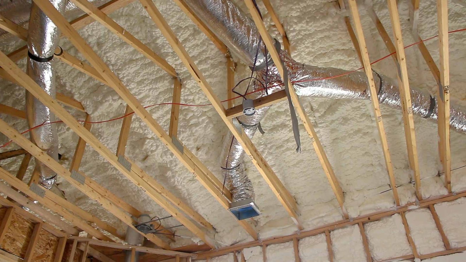 Flex duct running through open roof trusses before drywall
